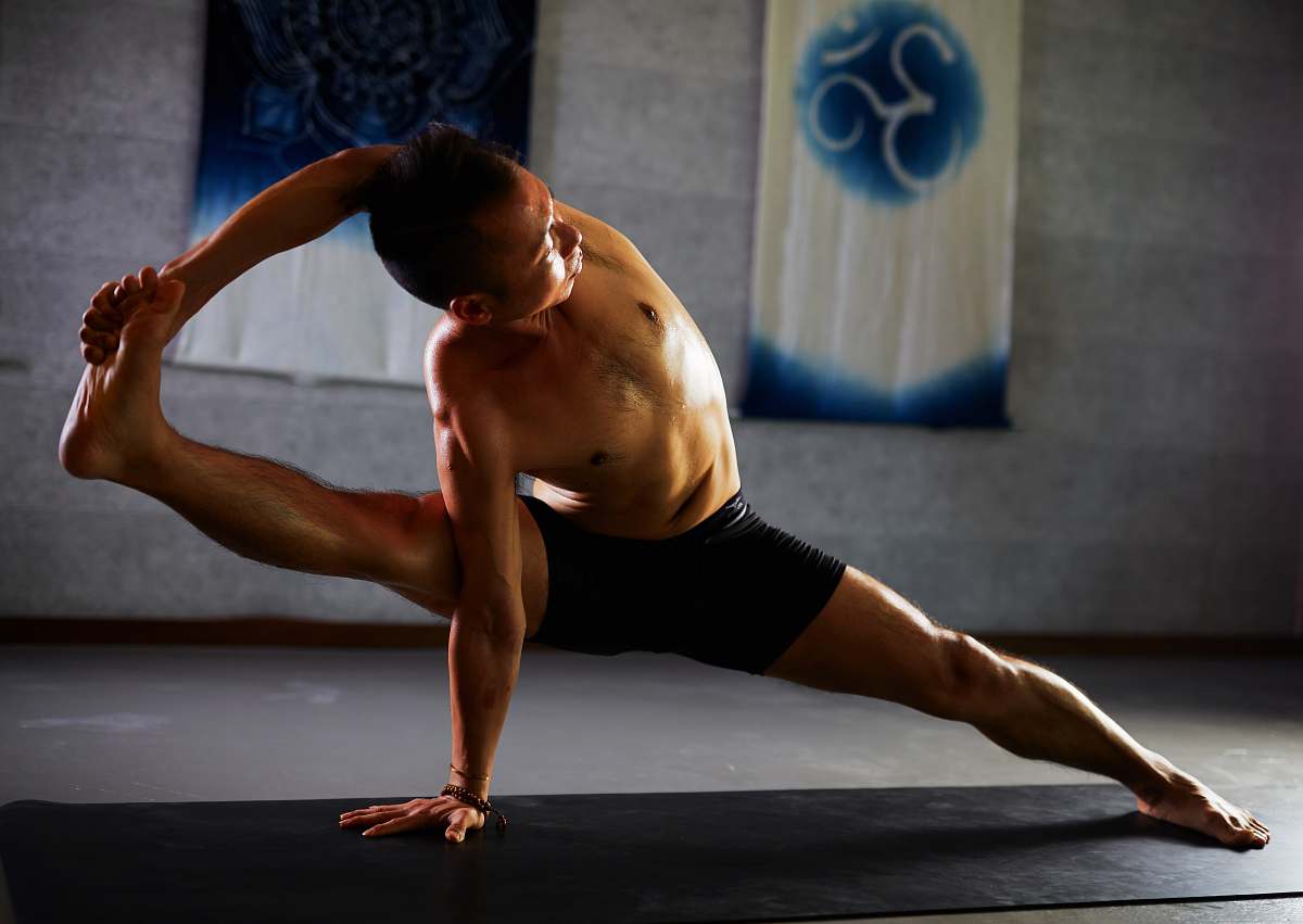 dance pose man stretching on black mat leisure activities